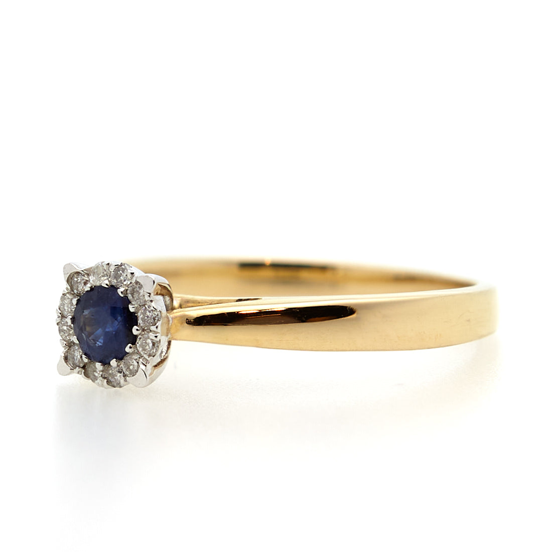 Yellow gold entourage ring with sapphire and diamond.